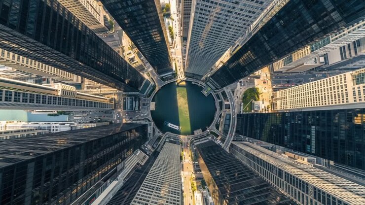A Stunning Aerial View of Urban Architecture Surrounding a Circular Water Body in a Bustling Metropolitan Area Showcasing Modern Skyscrapers and Vibrant City Life