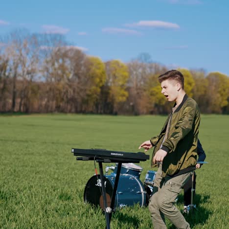 group playing music outside. young band play musical instruments on field