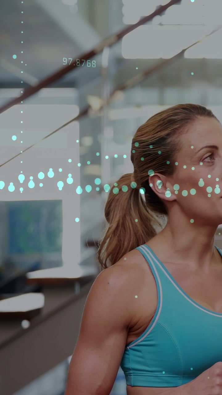 Vertical video: Woman turning smiling raising hand in gym as teal overlay sliding by showing stats