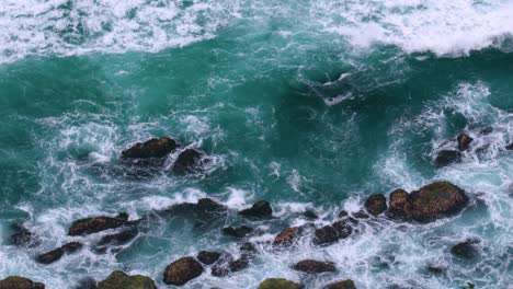 sea waves splashing on rocky shore of beach in byron bay