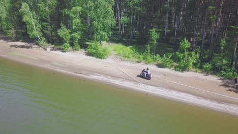 motorcycle and atv adventure on a lakeside beach