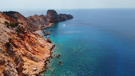 cliffs and clear sea waters. rocky cliffs meet vibrant blue waters under a clear sky, showcasing a serene coastal landscape filled with nature