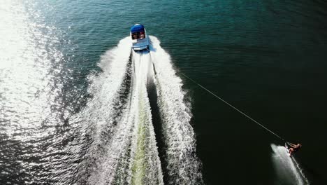 dramatic aerial shot of woman waterskiing