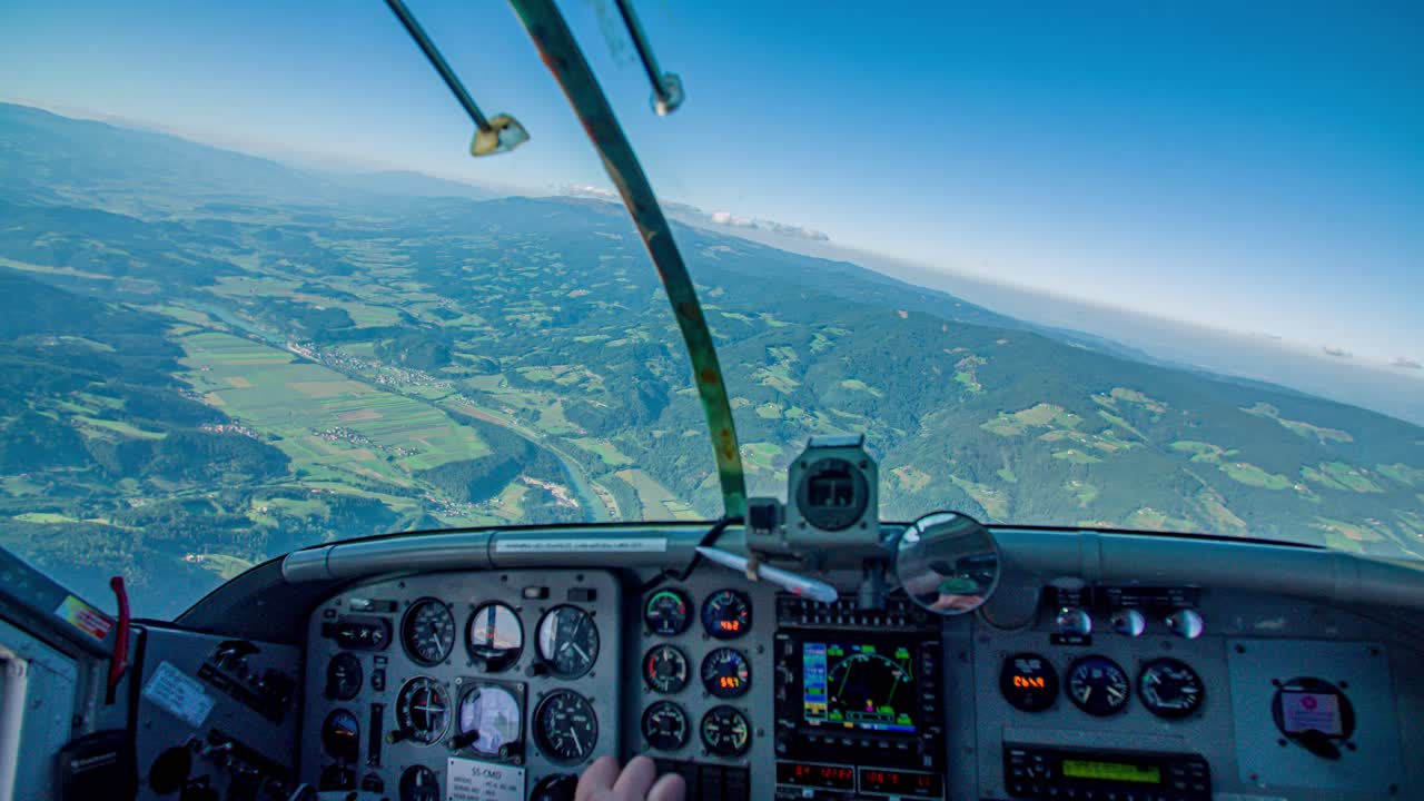 Pilot In Cockpit Flies Plane By Steering Left Over Carinthia Region, Slovenia