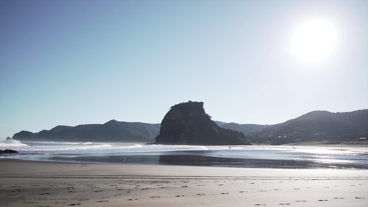 Beach scene with rock formation and waves