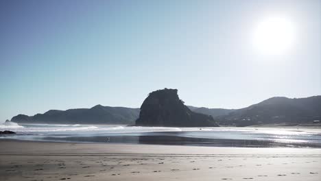 Beach scene with rock formation and waves