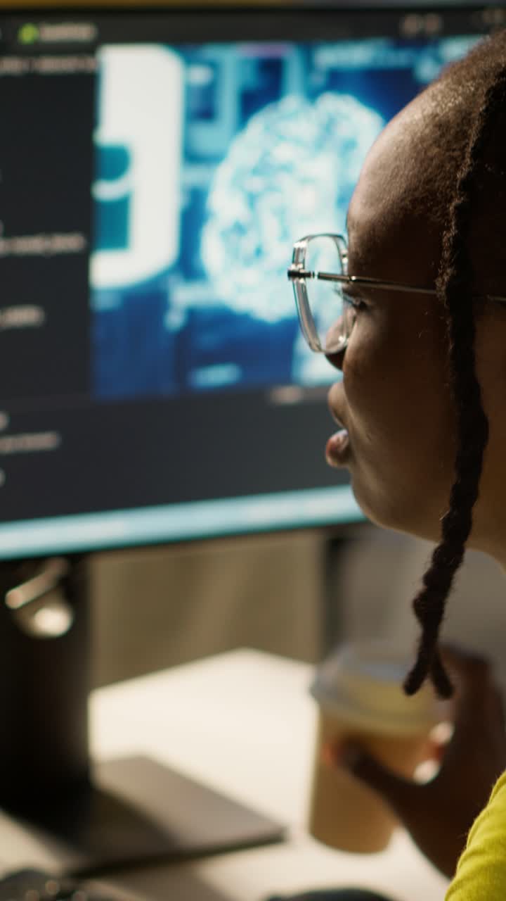 Vertical video Woman yawning while looking at artificial intelligence software on PC