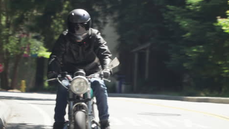 Motorcyclist-With-Leather-Jacket-Riding-on-a-Wooded-Road