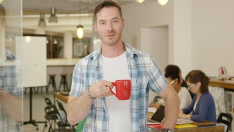 man with coffee in office