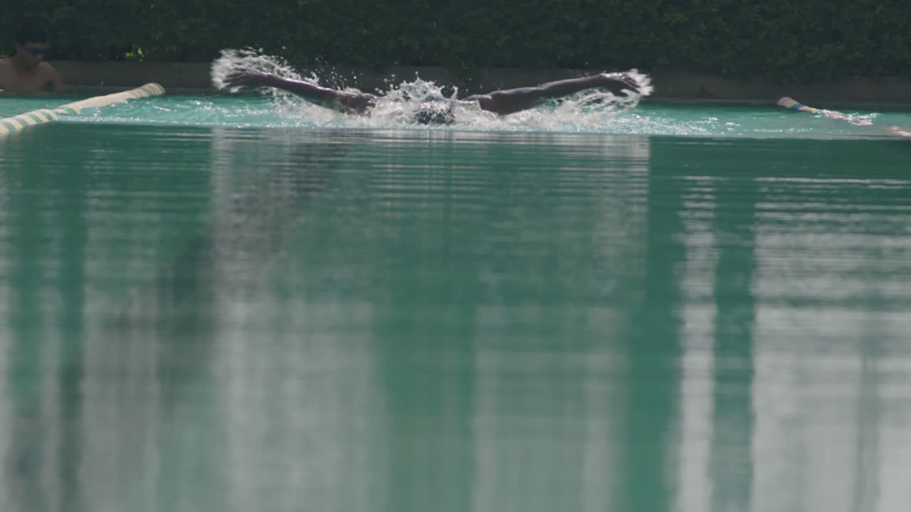 Athlete Swimming in Pool while Training Outdoors
