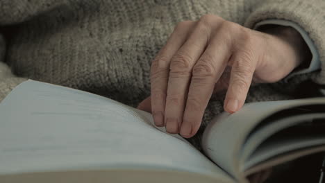 elderly man hands reading a book