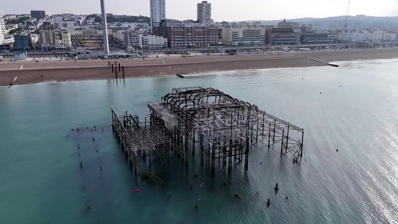Historic low tide reveals the hidden remains of Brighton’s West Pier in this dramatic aerial fly over of Victorian coastal engineering on the Sussex seafront.
