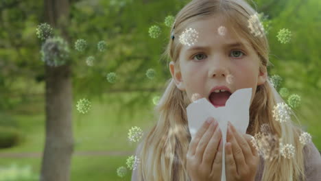 animation of macro covid-19 cells floating over caucasian girl sneezing into a tissue