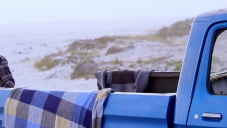 couple having fun near car on the beach 4k