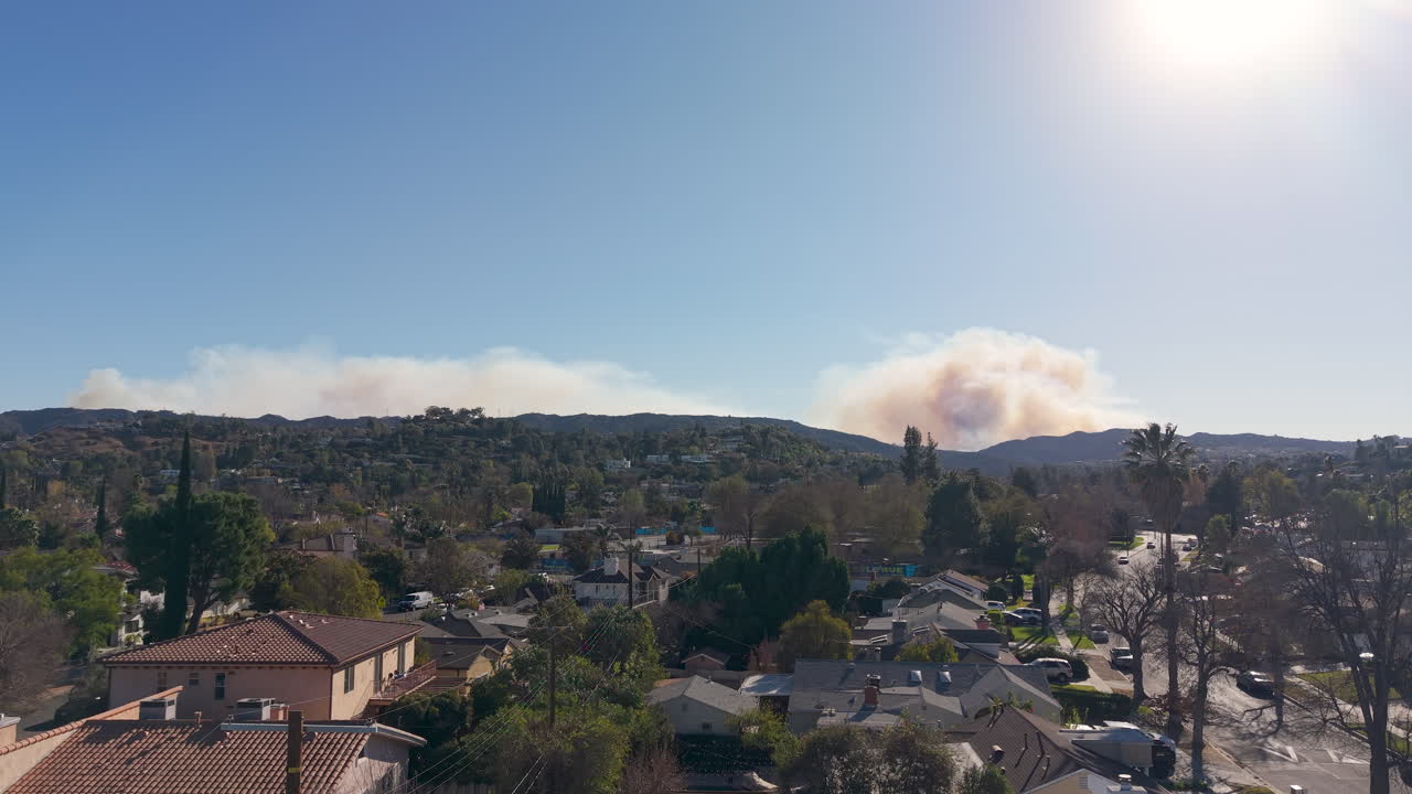 Drone footage of Pacific Palisades wild fires reaching the hills of Encino and Topanga, California during the afternoon.