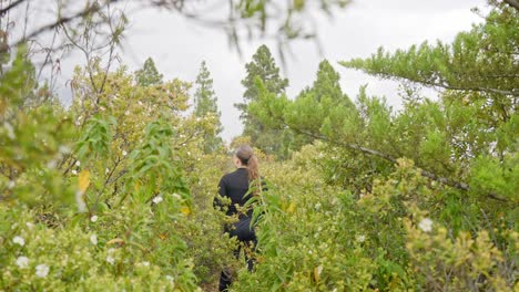 woman walking through plants, handheld dynamic