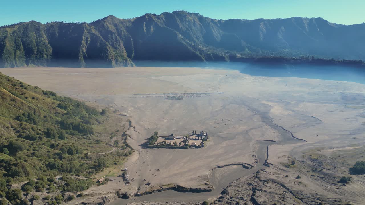 Aerial view of a deserted valley with a dense air of sand smoke, making a &amp;quot;ea of ​​sand&amp;quot; over the sky of the valley