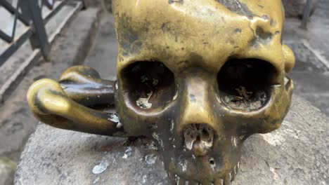 grinning bronze skull head artefact