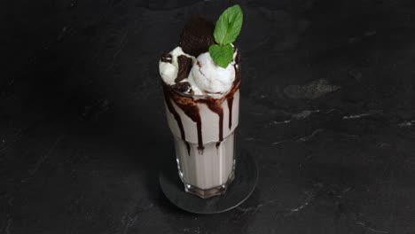 Chocolate-milkshake-with-vanilla-ice-and-mint-is-presented