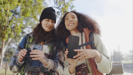 woman friends, binoculars and phone for hiking