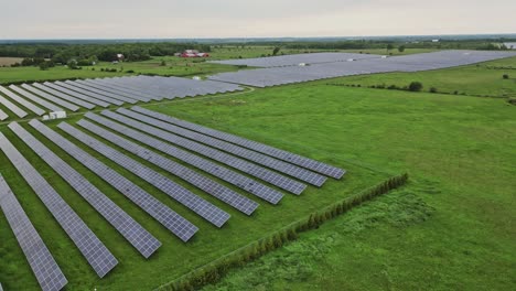 Aerial-View-Of-Solar-Panels-At-The-Power-Plant-On-Green-Field