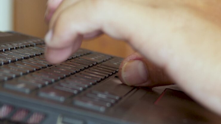Remote worker working from home laptop computer pressing buttons keys keyboard