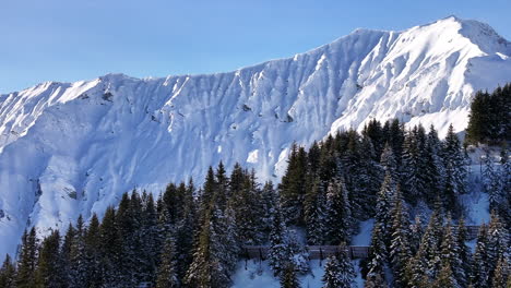 steep mountain sides covered by white snow illuminated by sunlight in adelboden switzerland