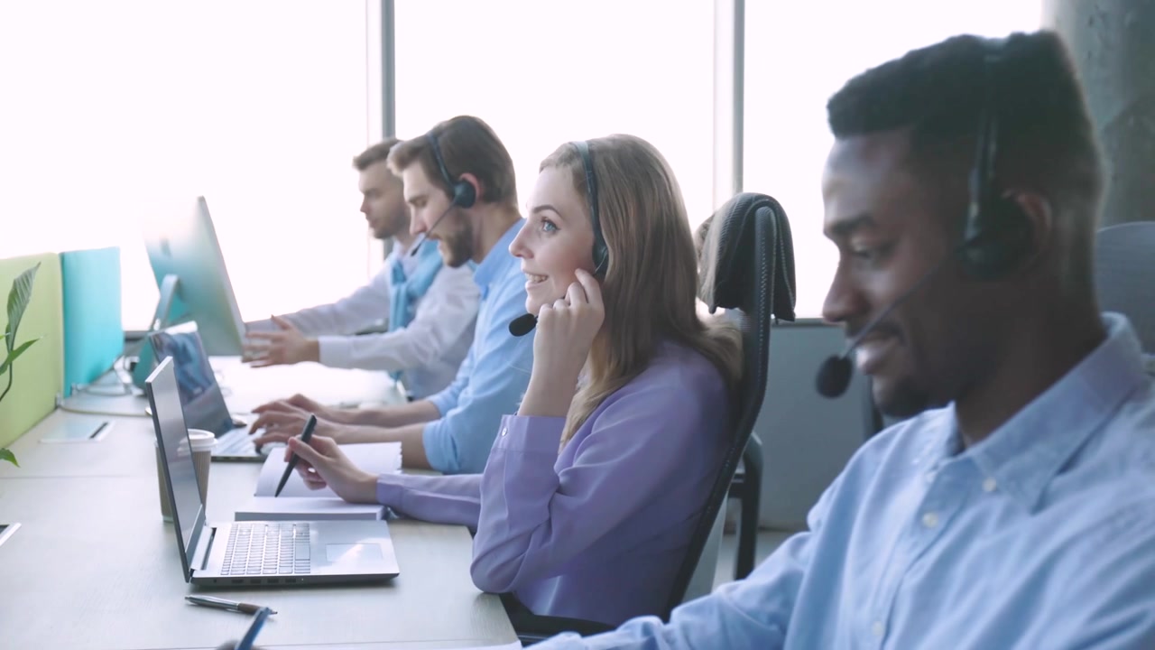 Diverse Team of Customer Service Agents Working in a Modern Office