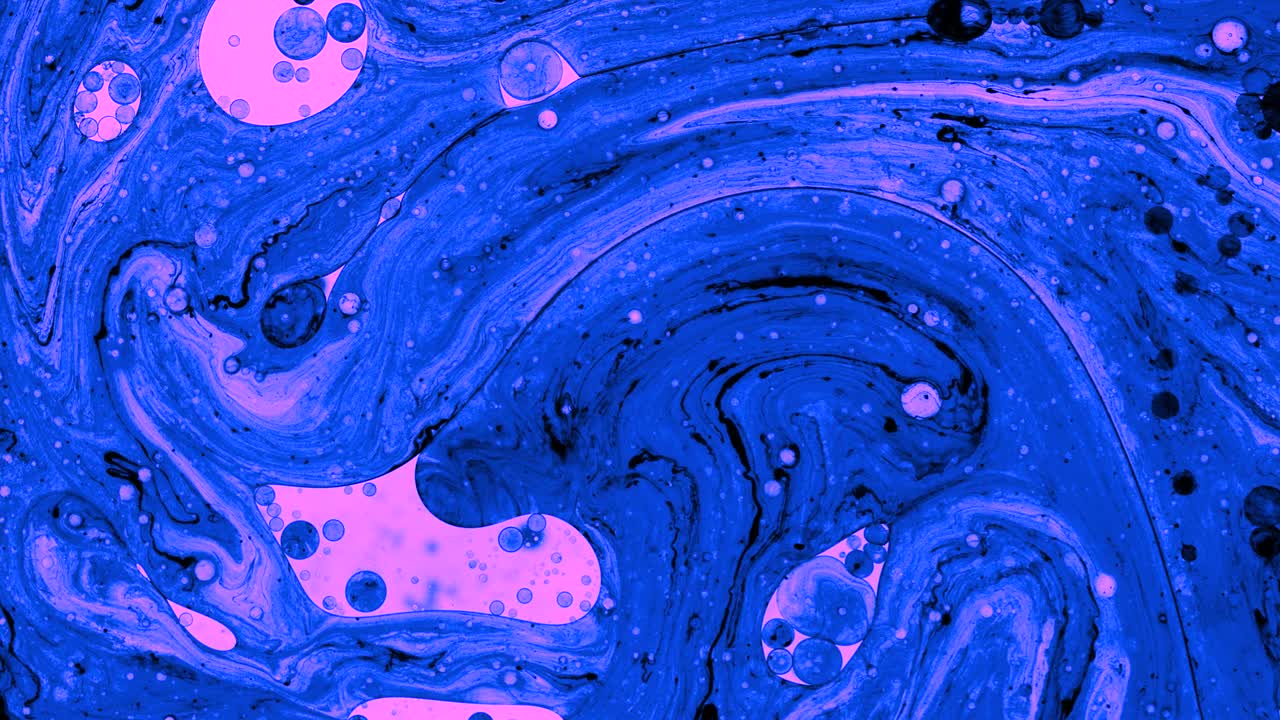 Colorful oil drops floating on water surface, top view. Fantastic abstract background. Bright bubbles moving and spreading. Close up 4k video of weird liquid structures. Scientific chemical experiment