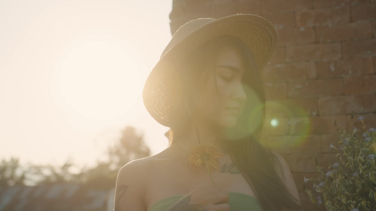 Woman with flower and straw hat