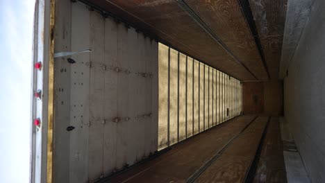 tilt down view inside an empty white semi-truck cargo trailer, vertical