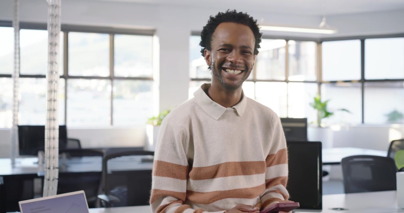 Young Man Using Smartphone in Modern Office