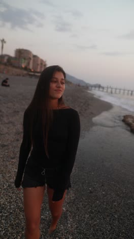 woman walking on the beach at sunset