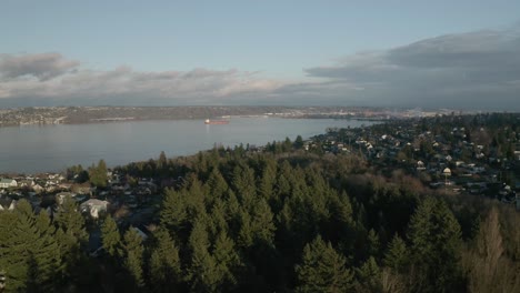 panoramic view of urban village with lush foliage by the calm river in proctor district, tacoma, washington