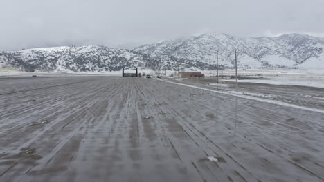 Flying-toward-a-wintery,-snowy-farm-in-Tehachapi,-CA