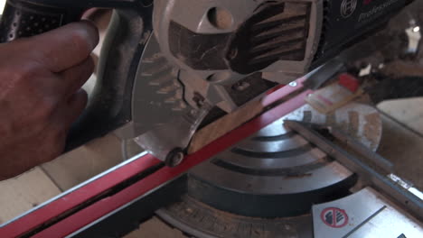 Cutting peace of wood with electric saw machine