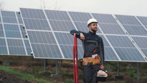 close-up portrait of a male solar power plant worker looking at the camera and smiling