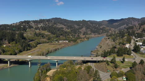 aerial flying forward shot of bridge over chetco river in brookings, oregon