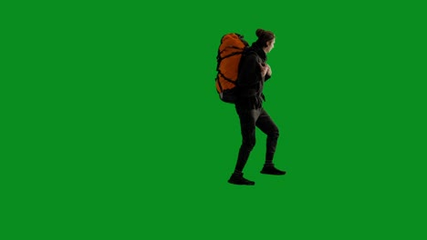 person hiking with a large backpack on a green screen