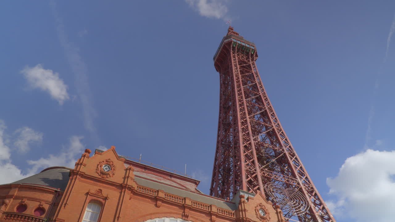 Blackpool Tower with blue sky and clouds racing by in two different directions
