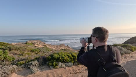 man photographing coastal landscape in melbourne, australia