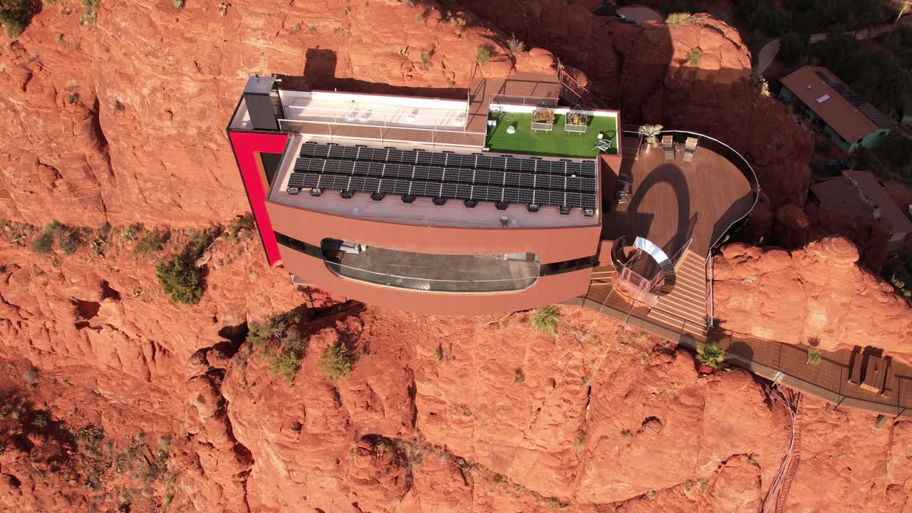 Aerial View of Futuristic House With Solar Panels Atop Red Sandstone Cliff in Landscape of Sedona Arizona USA