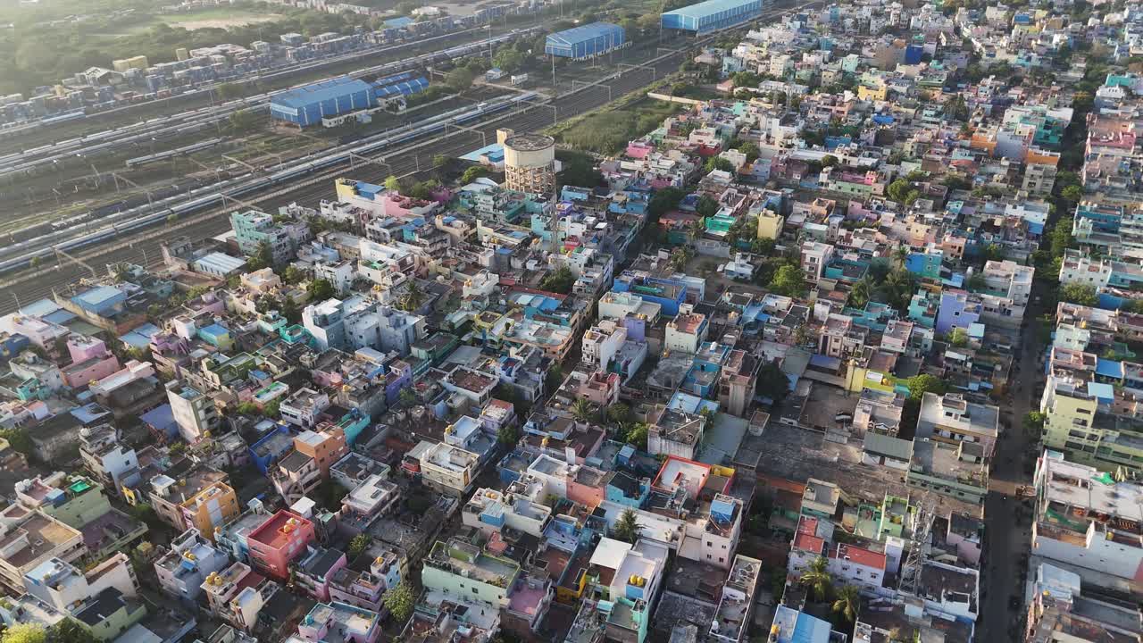Brightly colored residential rooftops in a coastal neighborhood with a visible cell tower at the center