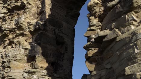 paredes de la ruina del castillo y arco contra el cielo azul tiro panorámico medio