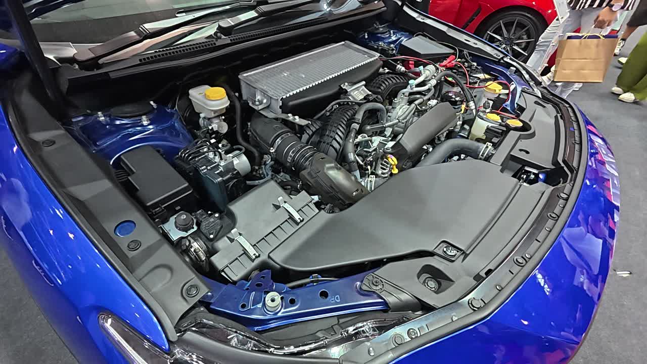 Newly revealed car engine in a showroom. The hood is open, showcasing the powerful engine to potential customers.