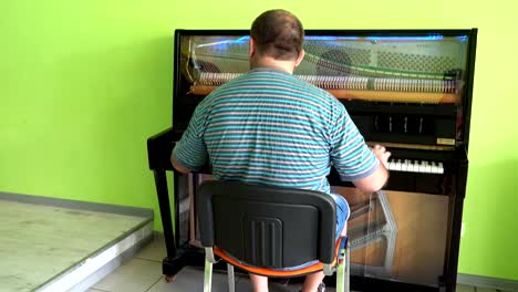 a man playing on a transparent piano