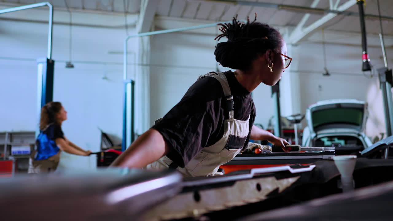 Repairman uses light to check inside car