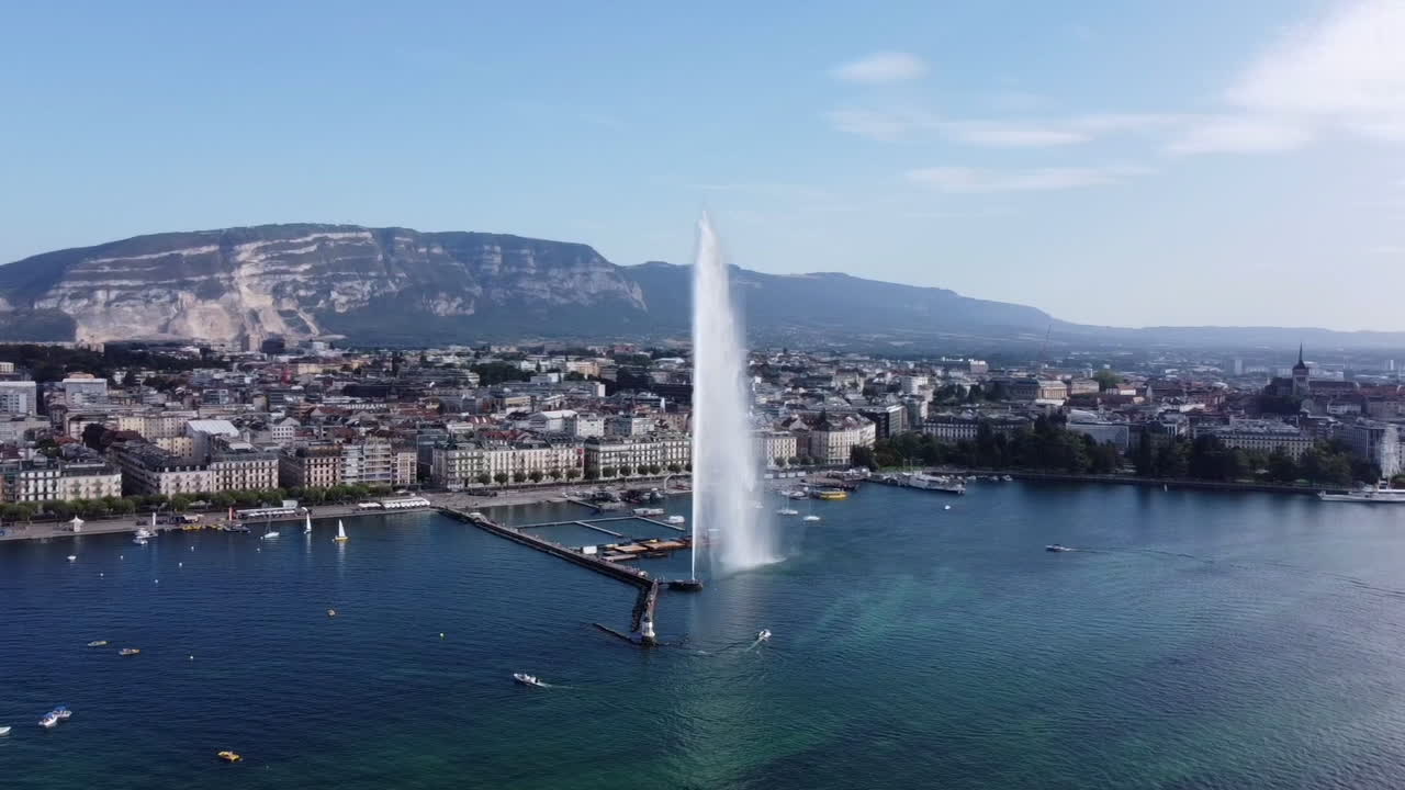 Aerial Orbit Around Jet d'Eau Water Fountain Lake Geneva - Sunny Day