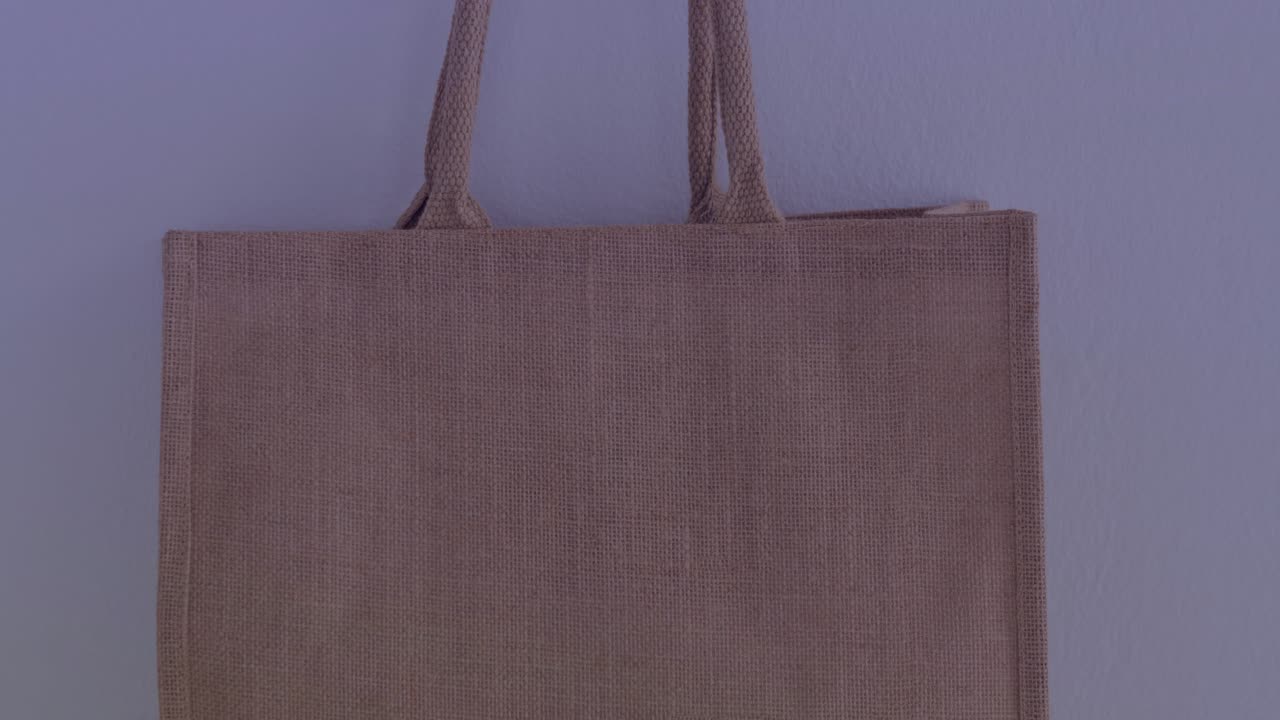 Overlay appearing over woven tote bag, HUD icons pulsing and streaks sweeping to highlight map