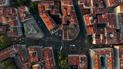 top down drone shot over red rooftops european city at sunset golden hour lyon france